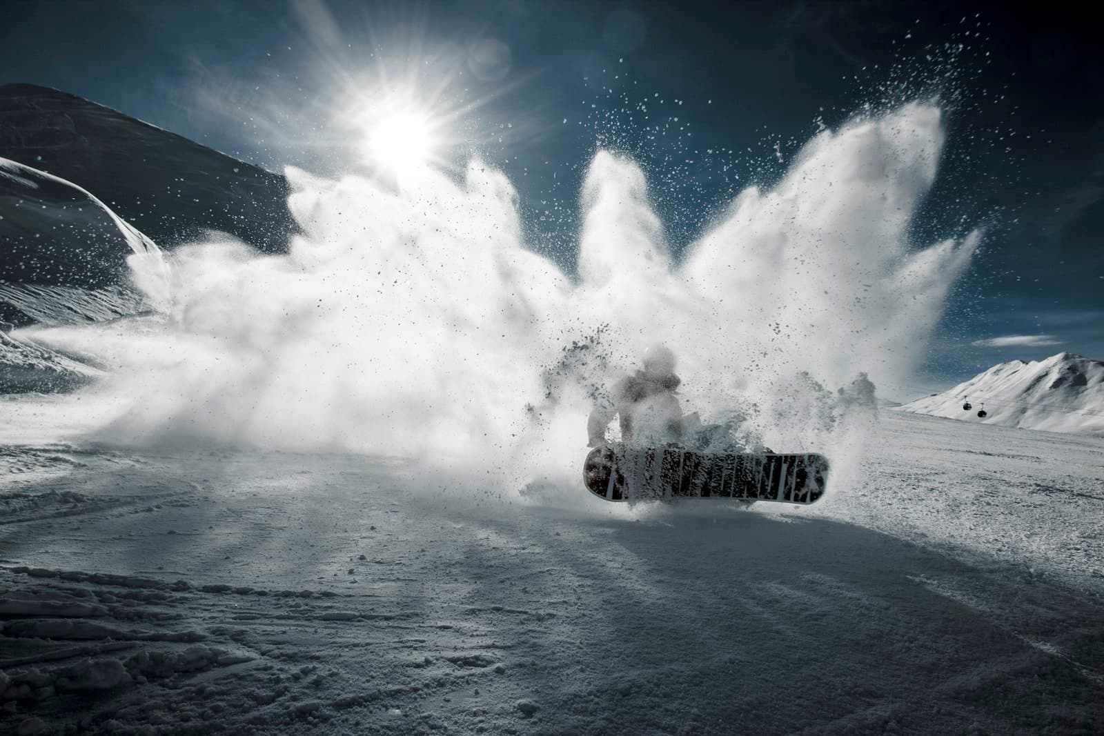 Snowboarder carving through powder